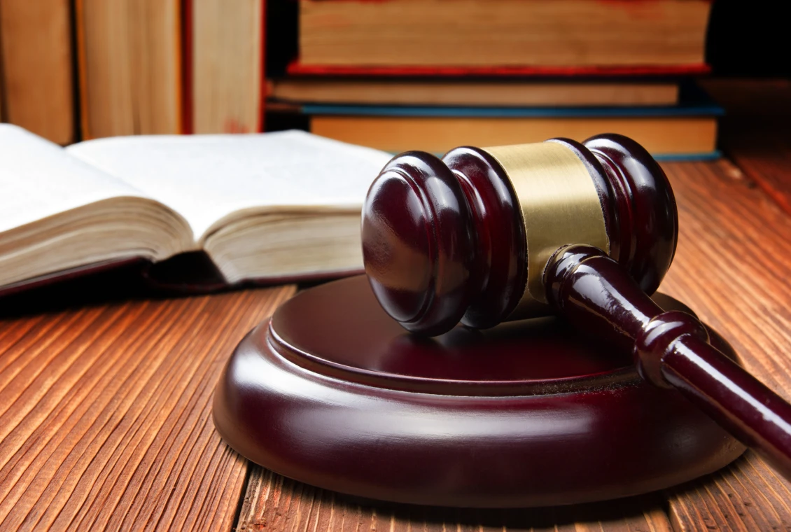 Courtroom gavel next to open book