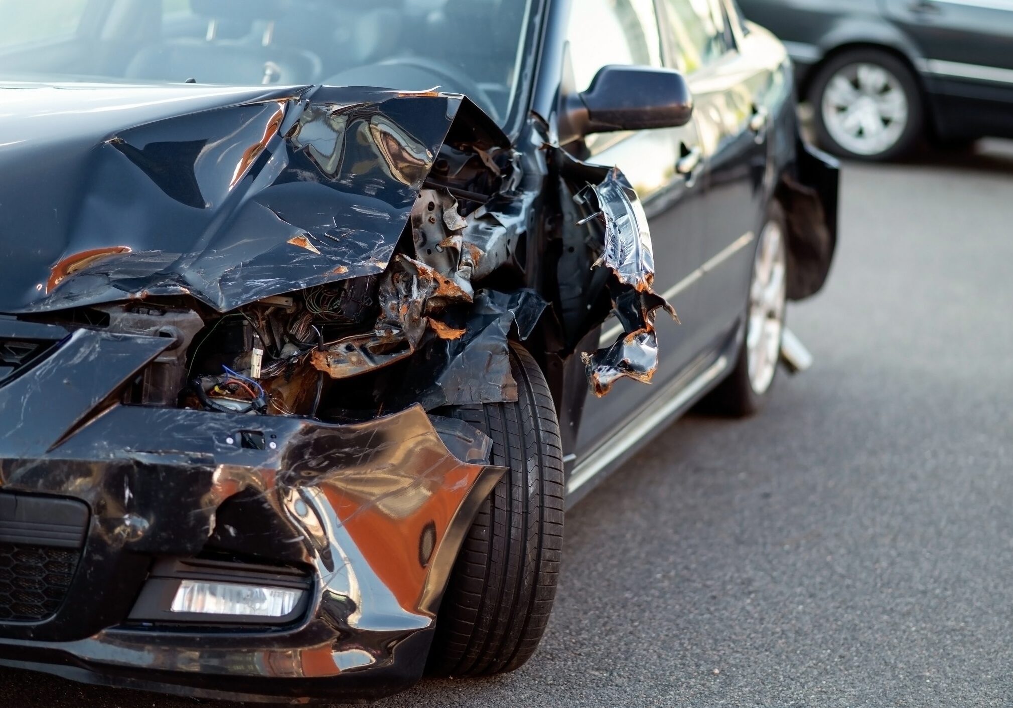A car with severe front-end damage after an accident.