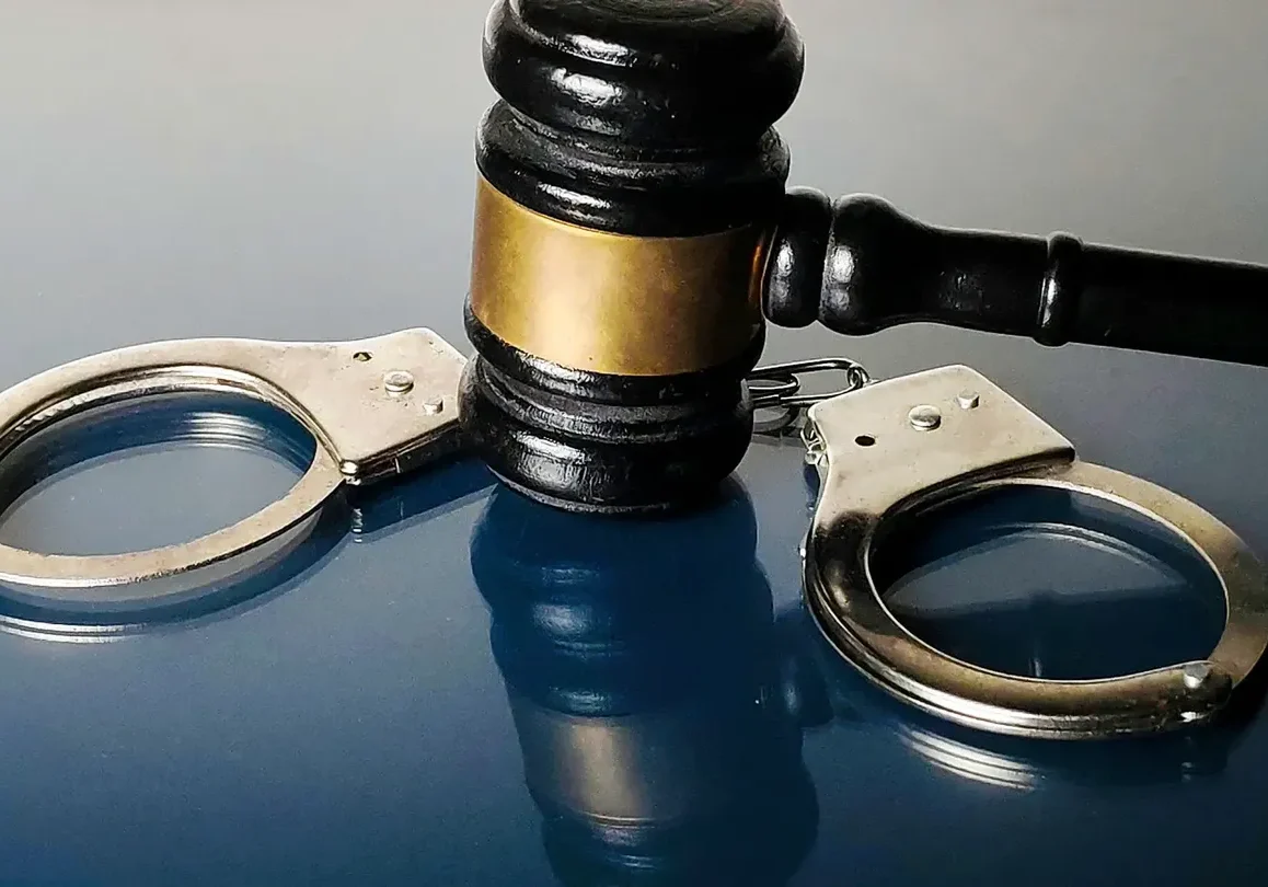 A judge's gavel resting on handcuffs symbolizing law and justice.